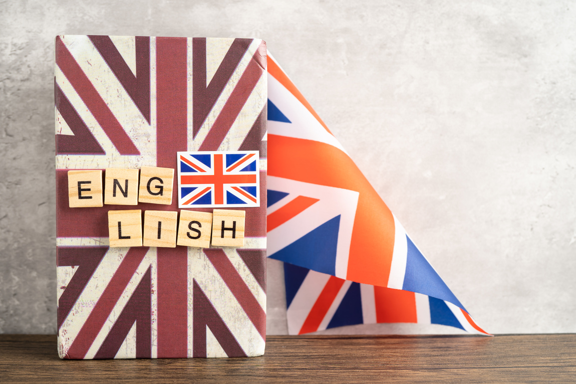 Word English on book with United Kingdom flag, learning English