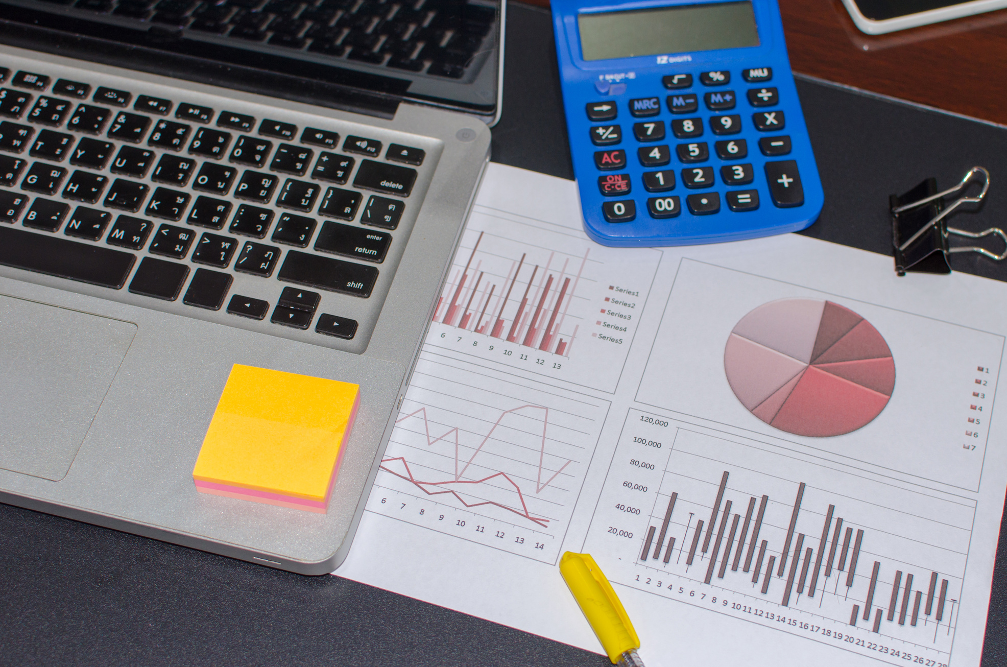 Top View of Laptop, Calculator, and Document